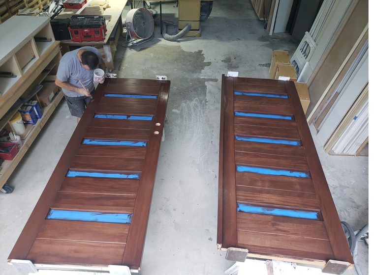Stained mahogany doors being finished