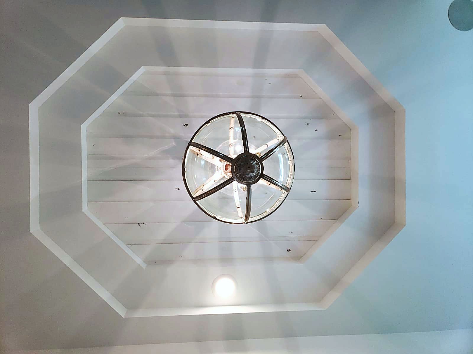 Octagon tray ceiling with a compass-spoke pendant light