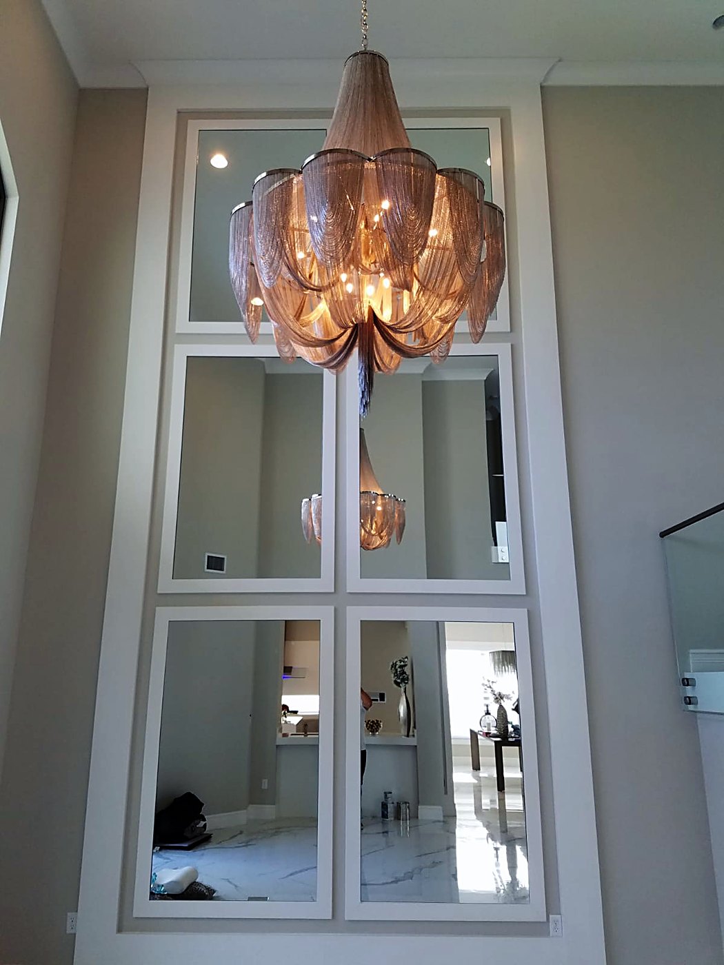 Two-story mirrored panel feature wall with custom millwork